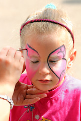 Image showing artist paints on face of little girl