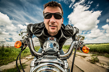 Image showing Biker racing on the road