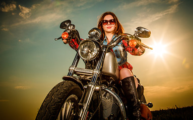 Image showing Biker girl sitting on motorcycle