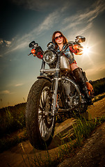 Image showing Biker girl sitting on motorcycle