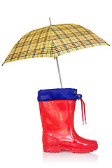 Image showing Rain boot and a yellow umbrella