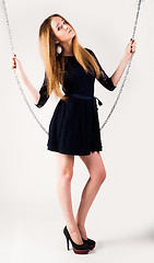 Image showing beautiful fashionable woman near chain swing