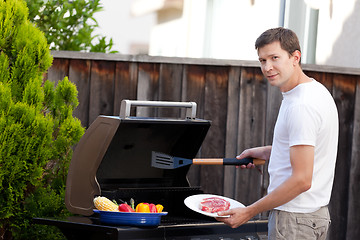 Image showing man grilling food