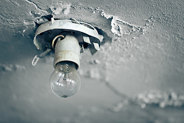 Image showing Old light bulb on ceiling of abandoned house