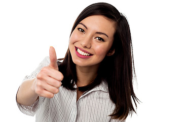 Image showing Smiling young woman showing thumbs up