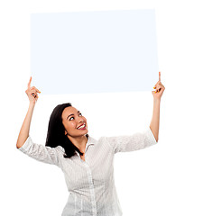 Image showing Woman holding up a blank white billboard