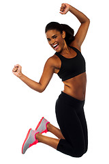 Image showing Woman in sportswear jumping with joy
