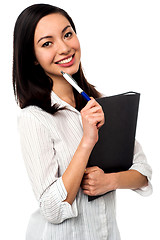 Image showing Female executive holding business file and pen