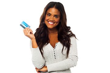 Image showing Young woman holding up a credit card