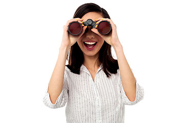 Image showing Businesswoman enjoying view through binoculars