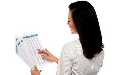 Image showing Back pose of businesswoman reading reports