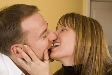 Image showing happy couple cooking and kissing