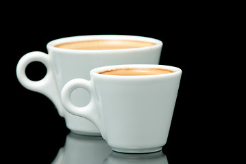 Image showing two white coffe cups on the black background