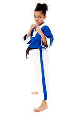 Image showing Serious karate girl with her fist in foreground