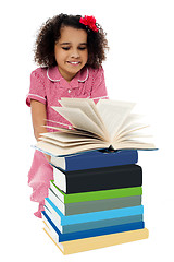Image showing Active kid reading a book and learning