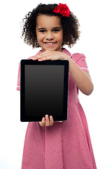 Image showing Smiling african american girl presenting tablet pc