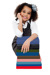 Image showing Happy school girl with pile of books