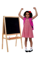 Image showing Excited beautiful little girl in school uniform