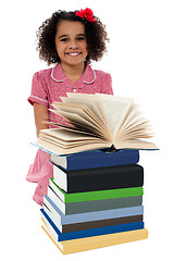 Image showing Portrait of pretty schoolgirl reading textbook