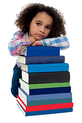 Image showing Sad little girl bored of reading