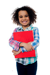 Image showing Smiling schoolgirl holding a book