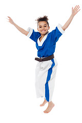 Image showing Enthusiastic young girl kid in karate uniform