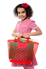 Image showing Pretty child carrying math equipment's in basket