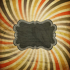 Image showing Grunge colorful rays background with vintage label for text. 