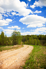 Image showing Country road under blue sky with white clouds, vertical shot