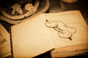 Image showing Vintage book and glasses. Closeup shot, retro styled.