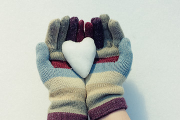 Image showing Snow heart in hands. Closeup shot