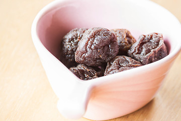 Image showing Close up delicious dry pink plum in cup 