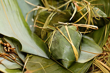 Image showing Rice dumpling on bamboo leaves