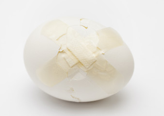 Image showing Cracked white egg with plastic plaster