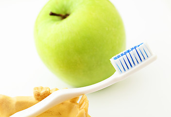Image showing Dental health care  concept, green apple and toothbrush