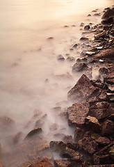 Image showing Sea coast wave and rock at sunset