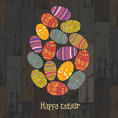 Image showing Easter eggs. Composed in one egg shape on wooden planks backgrou