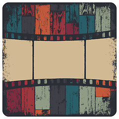 Image showing Film strip in grunge frame on colorful seamless wooden backgroun