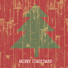 Image showing Christmas tree symbol and greetings on wooden planks texture. Ve