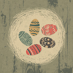 Image showing Easter eggs in nest on wooden texture. Easter background, retro 