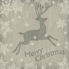 Image showing Christmas deer with snowflakes on wooden texture. Vector illustr