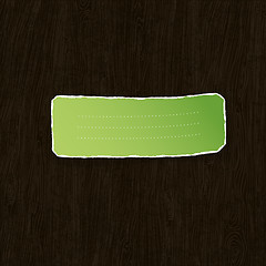 Image showing Green torn label on wooden texture. Vector illustration, EPS10