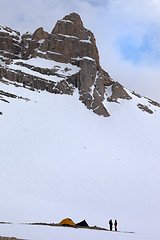 Image showing Tents and hikers in snow mountains