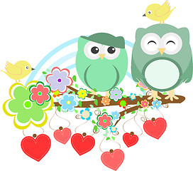 Image showing Two cute owls and bird on the flower tree branch