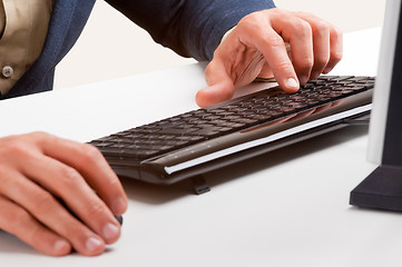 Image showing Man Working at a Computer Keyboard