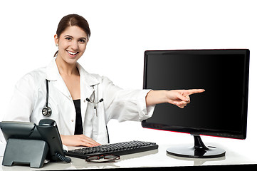 Image showing Female physician pointing at computer screen