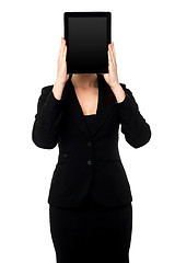 Image showing Woman hiding her face with tablet pc