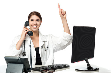 Image showing Female physician answering phone call