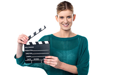 Image showing Young girl posing with clapperboard