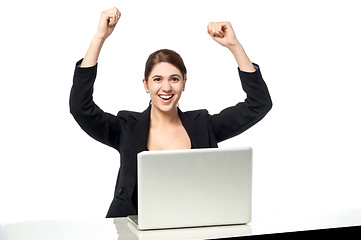 Image showing Excited businesswoman raising her arms up